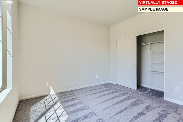 unfurnished bedroom featuring carpet floors, baseboards, and a closet