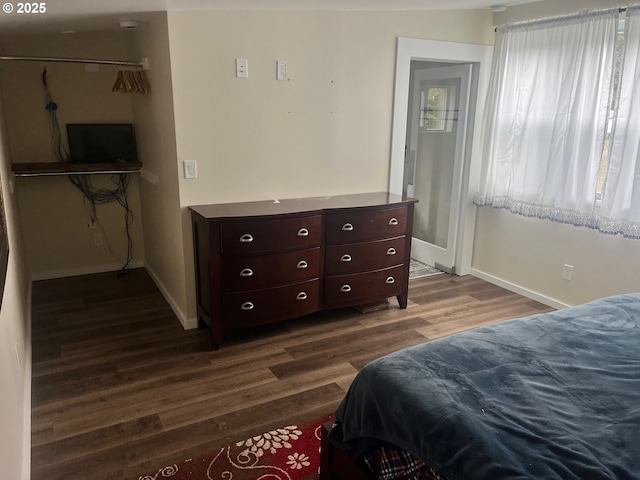 865 E Columbia River Hwy, Clatskanie, OR 97016 - bedroom featuring dark wood-style floors and baseboards