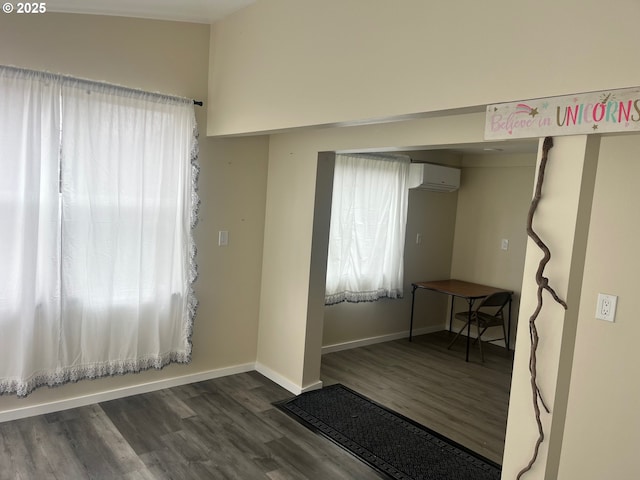 865 E Columbia River Hwy, Clatskanie, OR 97016 - unfurnished room with wood finished floors, a wall unit AC, baseboards, and plenty of natural light