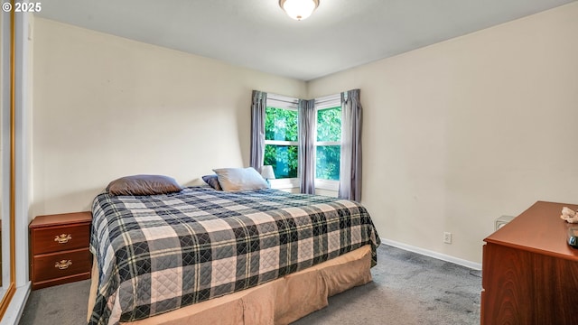 bedroom featuring carpet and baseboards