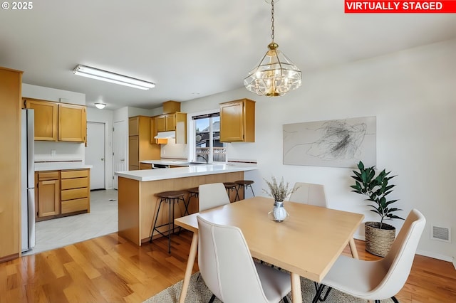 33333 Adam Ct, Scappoose, OR 97056 - dining room featuring a chandelier and light wood-type flooring