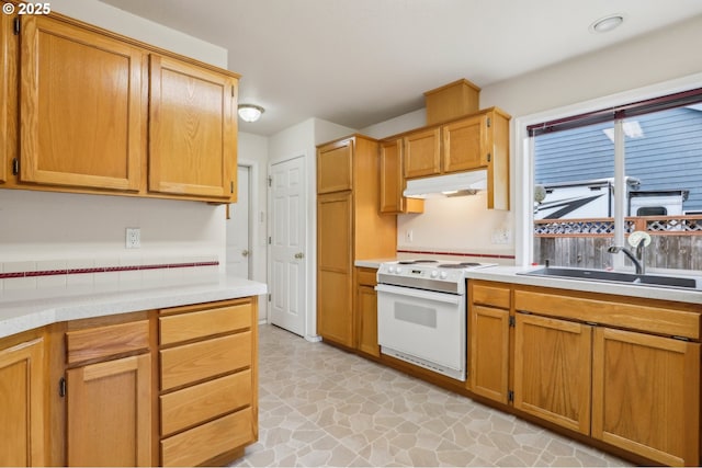 33333 Adam Ct, Scappoose, OR 97056 - kitchen featuring white range with electric cooktop, a sink, under cabinet range hood, and light countertops
