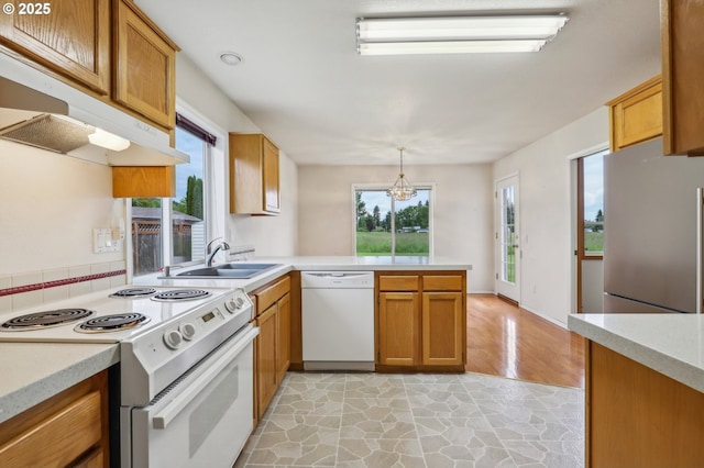 33333 Adam Ct, Scappoose, OR 97056 - kitchen with white appliances, a peninsula, a sink, and light countertops