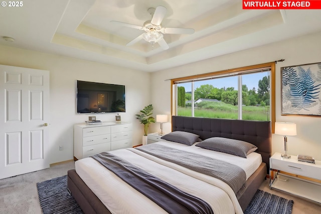 33333 Adam Ct, Scappoose, OR 97056 - bedroom with a raised ceiling, light carpet, and ceiling fan