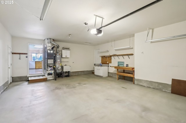 33333 Adam Ct, Scappoose, OR 97056 - garage featuring water heater, a garage door opener, a sink, and a workshop area
