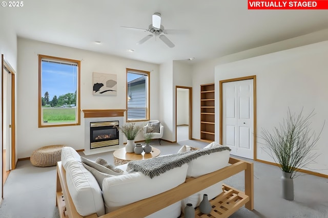 33333 Adam Ct, Scappoose, OR 97056 - living area featuring a glass covered fireplace and a ceiling fan