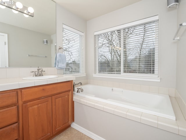 full bath featuring tile patterned floors, a garden tub, and vanity