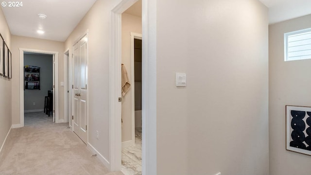 hallway with light colored carpet