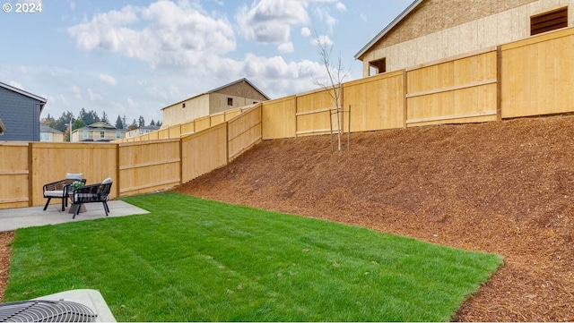 view of yard with central AC unit and a patio area