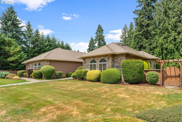 1508 NW 151st St, Vancouver, WA 98685 - view of front of house featuring stone siding, a gate, and roof with shingles