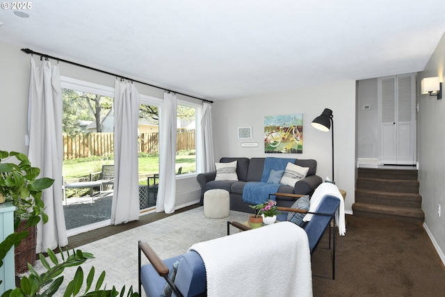 living room with visible vents, baseboards, carpet floors, and stairway