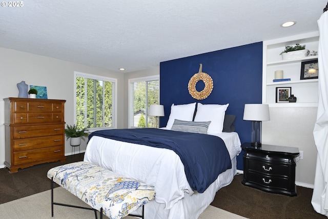 carpeted bedroom featuring recessed lighting and a textured ceiling