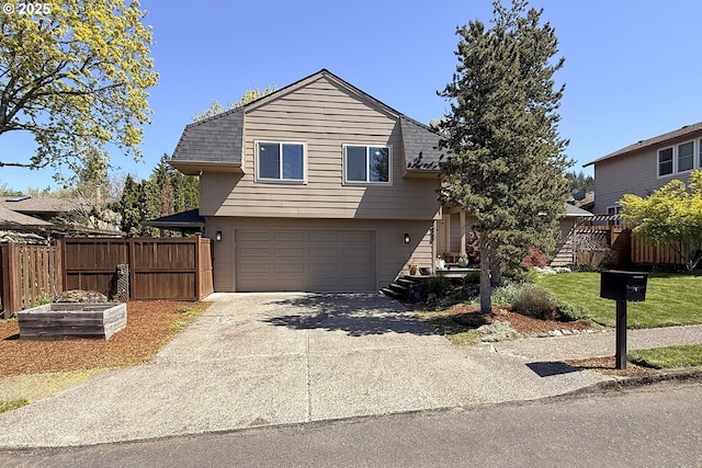 split level home with an attached garage, concrete driveway, fence, and roof with shingles