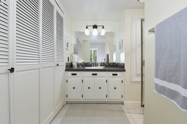 full bathroom with tile patterned floors and vanity