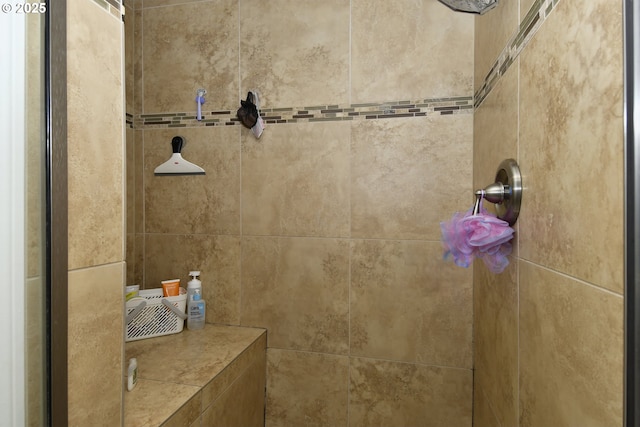 full bath featuring a tile shower