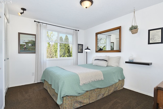bedroom featuring baseboards and carpet flooring