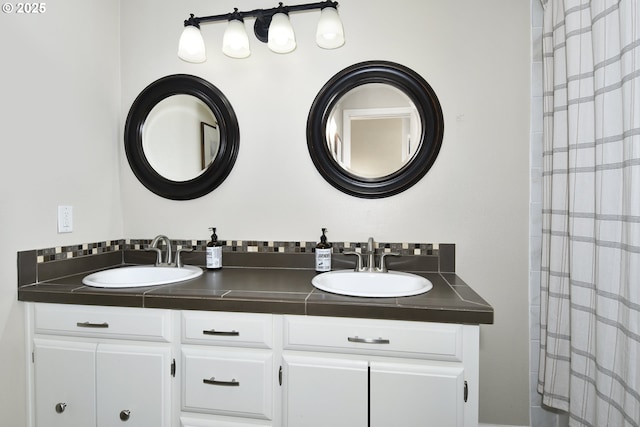 bathroom with a shower with curtain, double vanity, and a sink