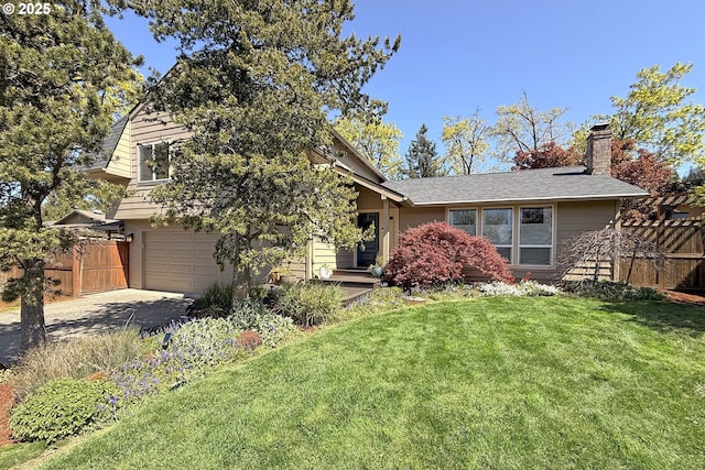 view of front of property featuring fence, an attached garage, a front yard, and concrete driveway