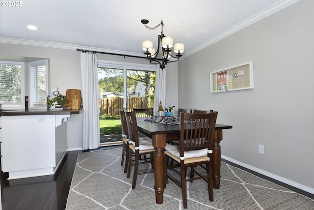 dining area with baseboards, an inviting chandelier, ornamental molding, and dark wood-style flooring