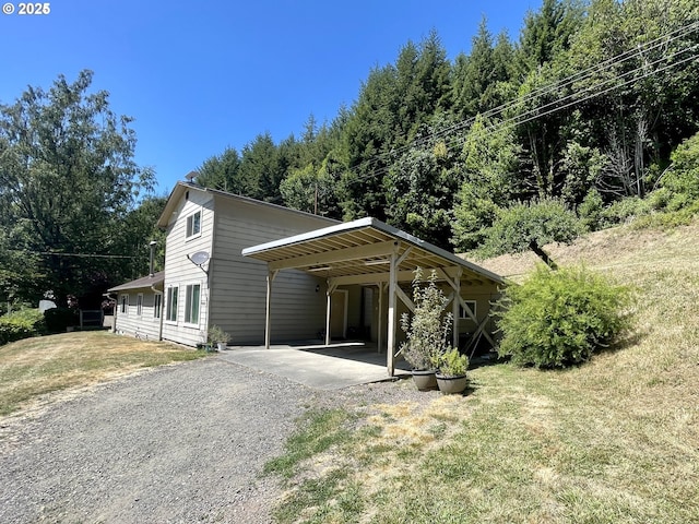 96343 Coos-Sumner Ln, Coos Bay, OR 97420 - view of front facade featuring driveway, a front yard, and a carport