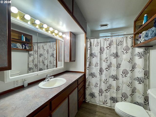 96343 Coos-Sumner Ln, Coos Bay, OR 97420 - full bathroom featuring toilet, wood finished floors, vanity, and a shower with shower curtain