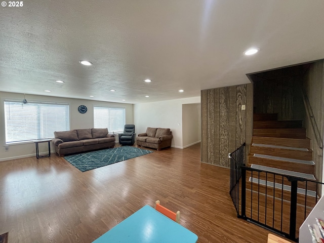 96343 Coos-Sumner Ln, Coos Bay, OR 97420 - living room with recessed lighting, wood finished floors, baseboards, a textured ceiling, and stairs