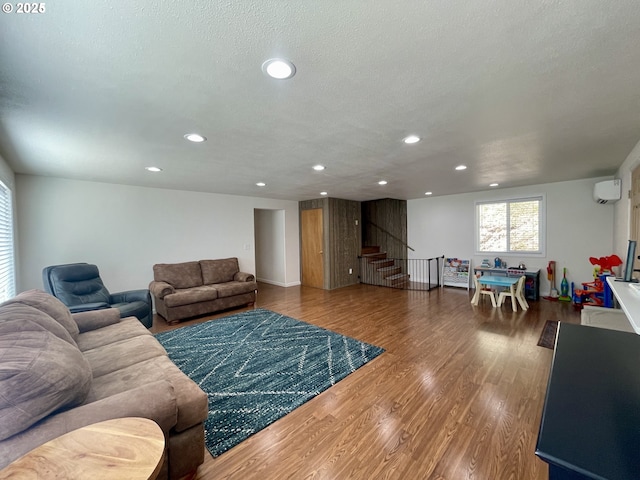 96343 Coos-Sumner Ln, Coos Bay, OR 97420 - living area with stairway, wood finished floors, a wall mounted air conditioner, and recessed lighting