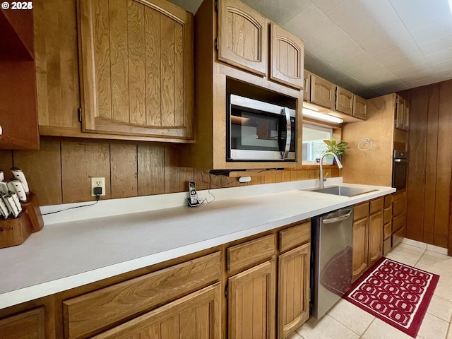 96343 Coos-Sumner Ln, Coos Bay, OR 97420 - kitchen with a sink, appliances with stainless steel finishes, light countertops, light tile patterned floors, and brown cabinetry