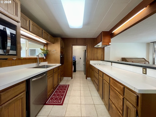 96343 Coos-Sumner Ln, Coos Bay, OR 97420 - kitchen with appliances with stainless steel finishes, a sink, wood walls, light countertops, and light tile patterned flooring
