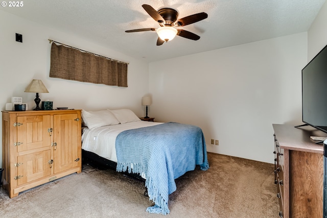 bedroom with a ceiling fan, a textured ceiling, and light colored carpet