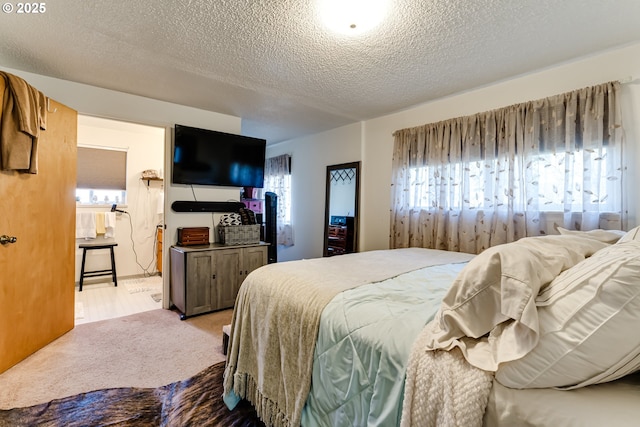 bedroom featuring carpet floors and a textured ceiling