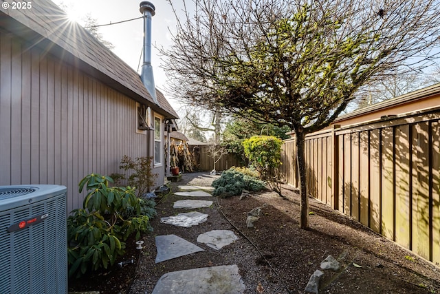 view of yard featuring a fenced backyard and central AC unit