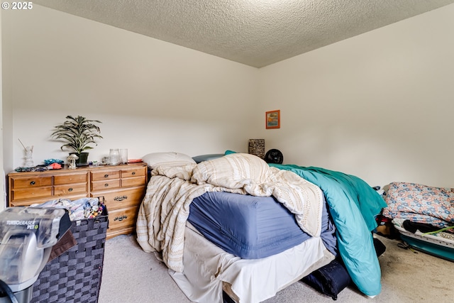 bedroom featuring light colored carpet and a textured ceiling