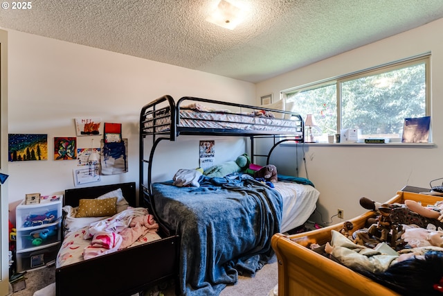 bedroom with carpet floors and a textured ceiling