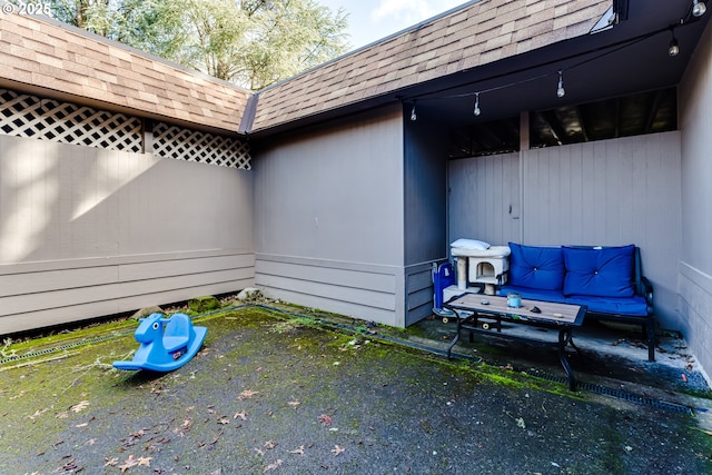 view of side of property featuring a shingled roof and mansard roof