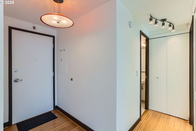 entryway featuring light wood-style flooring and baseboards