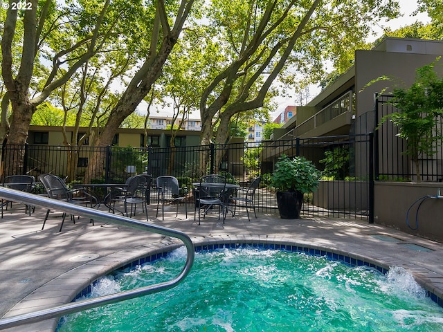 view of swimming pool with a patio area and fence