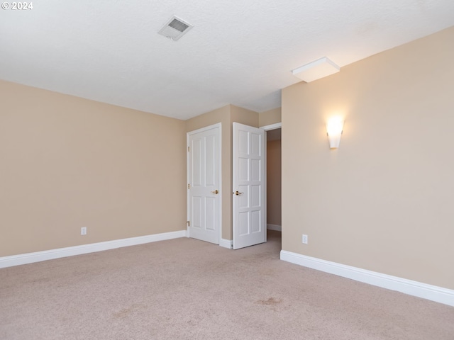 spare room with light colored carpet