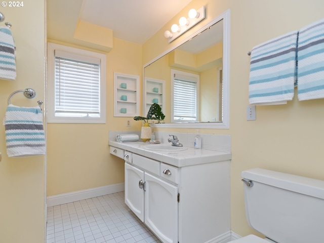 bathroom featuring vanity, tile patterned floors, and toilet