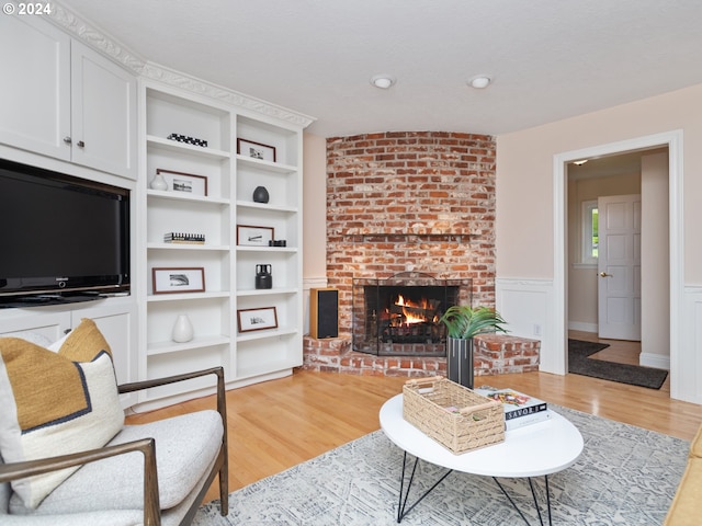 living room with a fireplace and light hardwood / wood-style floors