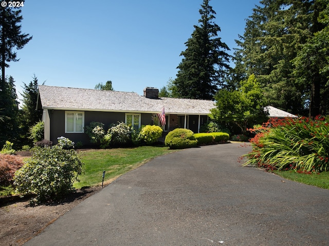 single story home featuring a front lawn