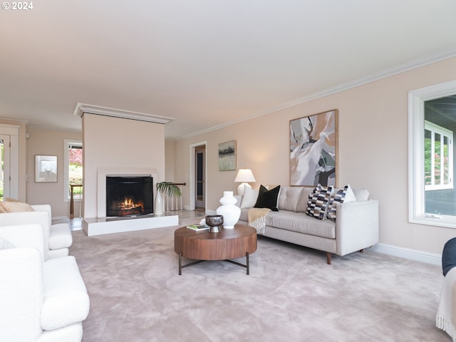 living room featuring light carpet, crown molding, and a healthy amount of sunlight