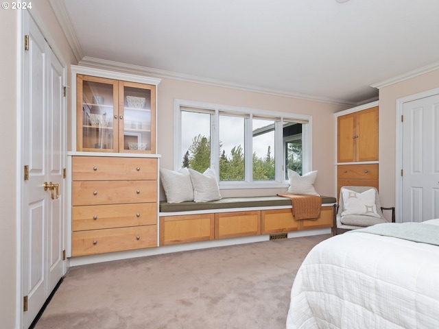 carpeted bedroom with ornamental molding