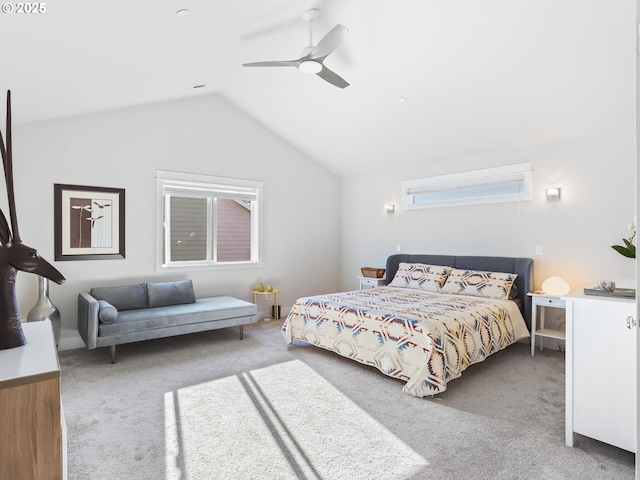 carpeted bedroom with ceiling fan and vaulted ceiling