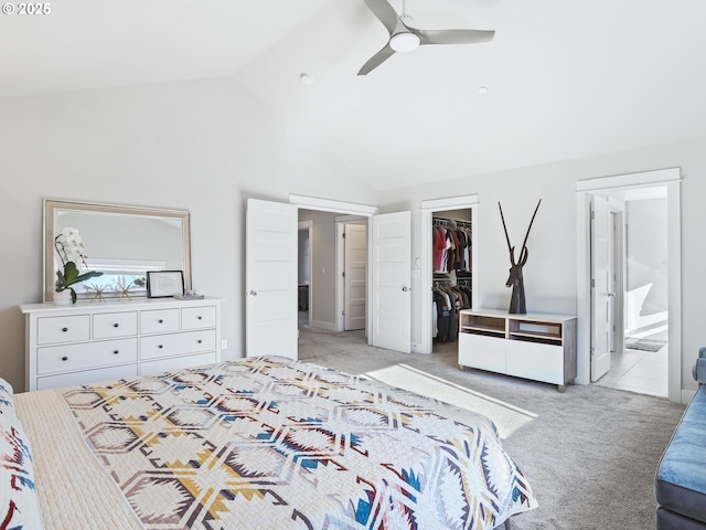 carpeted bedroom with ensuite bathroom, a spacious closet, high vaulted ceiling, a closet, and ceiling fan