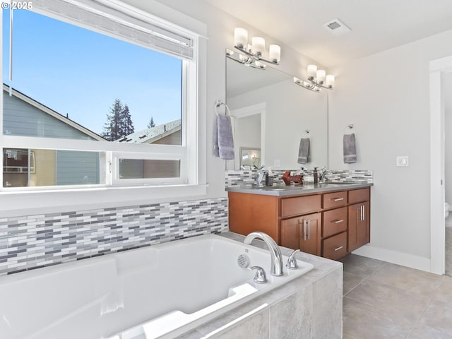 bathroom featuring vanity, tiled bath, and tile patterned floors