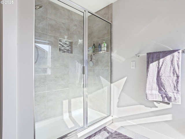 bathroom featuring a shower with shower door