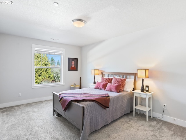 bedroom featuring carpet flooring and a textured ceiling