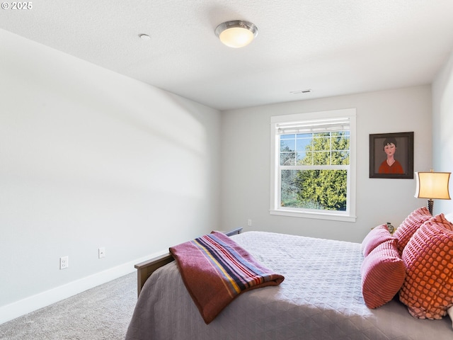 carpeted bedroom with a textured ceiling