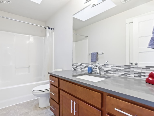 full bathroom featuring shower / bath combo, a skylight, tasteful backsplash, vanity, and toilet